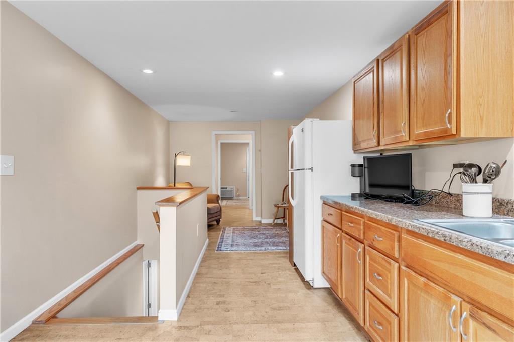 461 Manor Road Wexford, PA 15090 - Photo 29 of 43 a kitchen with granite countertop a sink stove and refrigerator