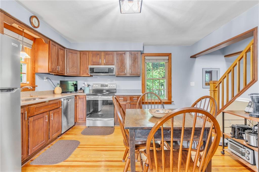 461 Manor Road Wexford, PA 15090 - Photo 9 of 43 a kitchen with stainless steel appliances granite countertop a stove a sink dishwasher and a refrigerator with wooden floor