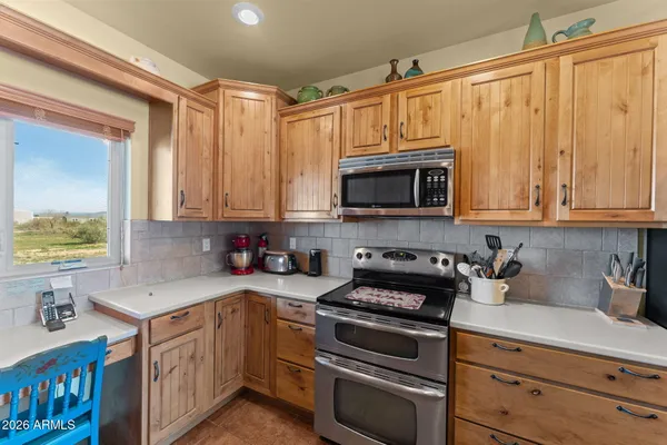 a kitchen with stainless steel appliances a stove a microwave and cabinets