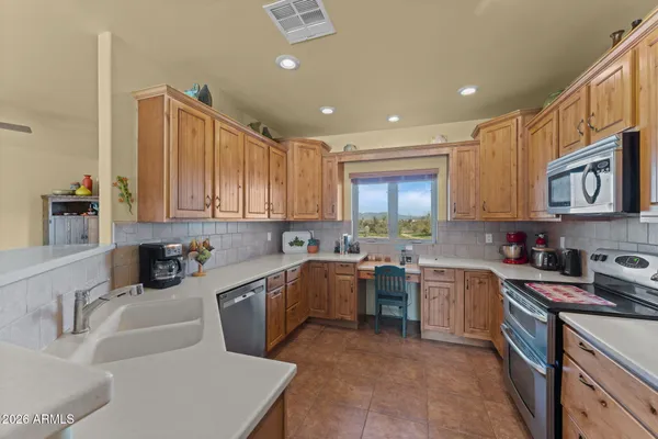 a kitchen that has a sink and a stove in it
