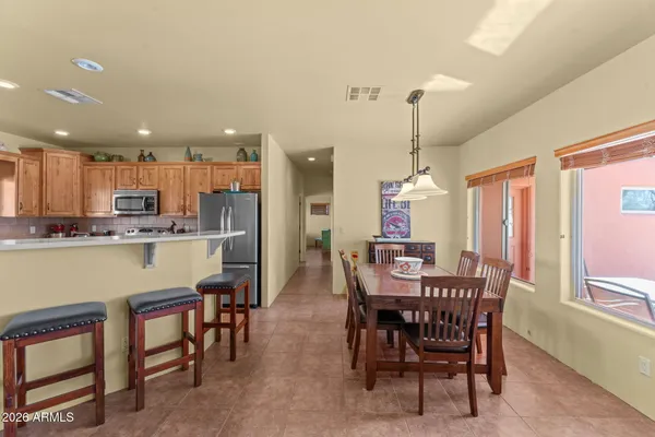 a dining room with a table chairs and a kitchen