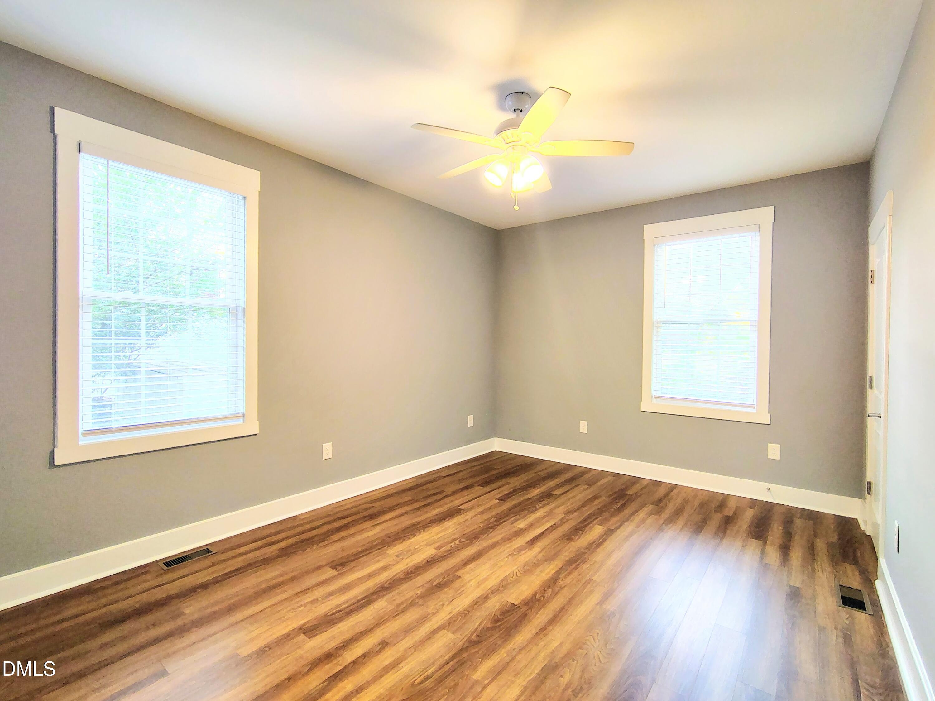 307 Chaplin Street Wendell, NC 27591 - Photo 14 of 24 a view of an empty room with wooden floor and a window