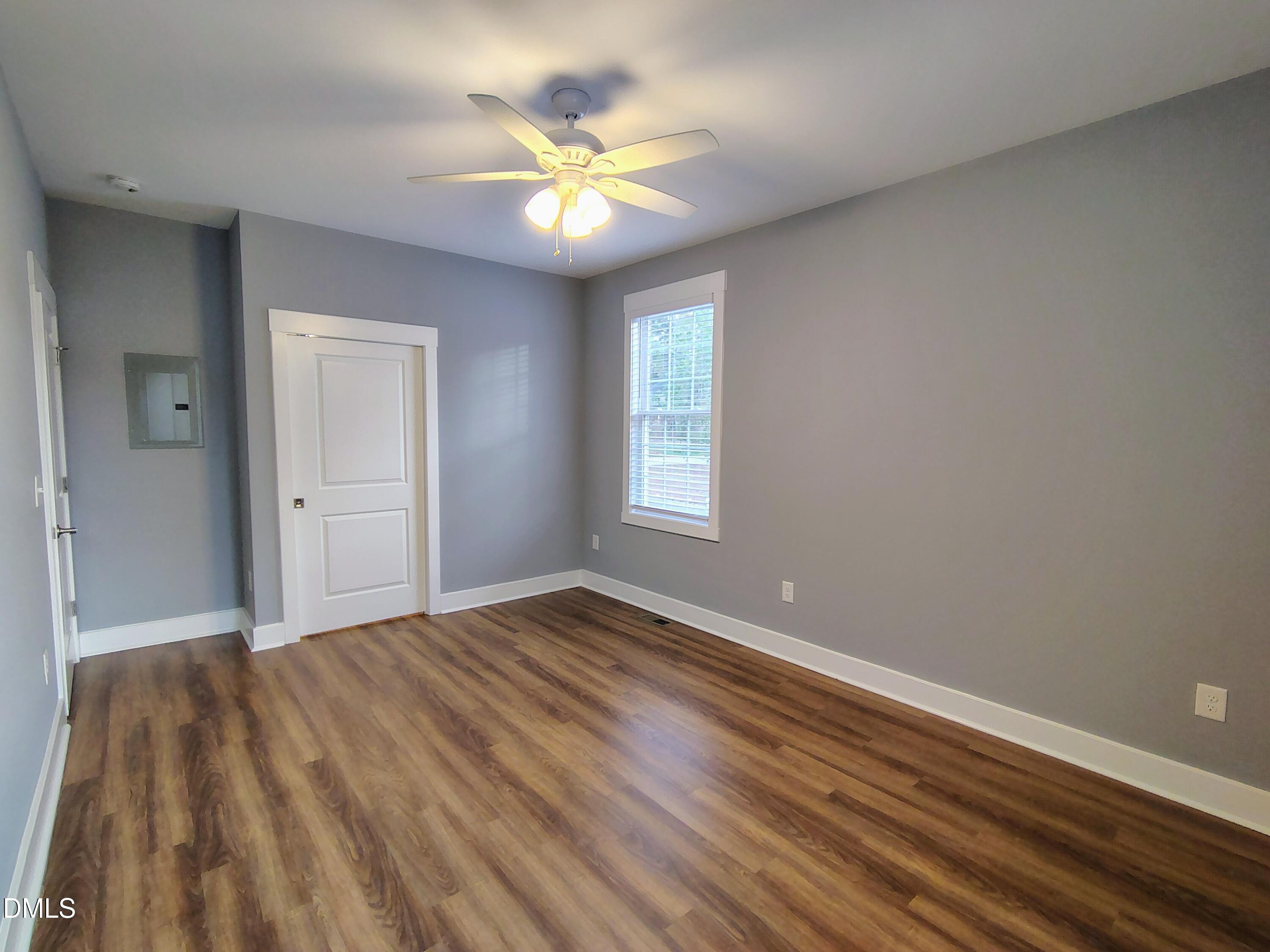 307 Chaplin Street Wendell, NC 27591 - Photo 18 of 24 a view of an empty room with window and wooden floor