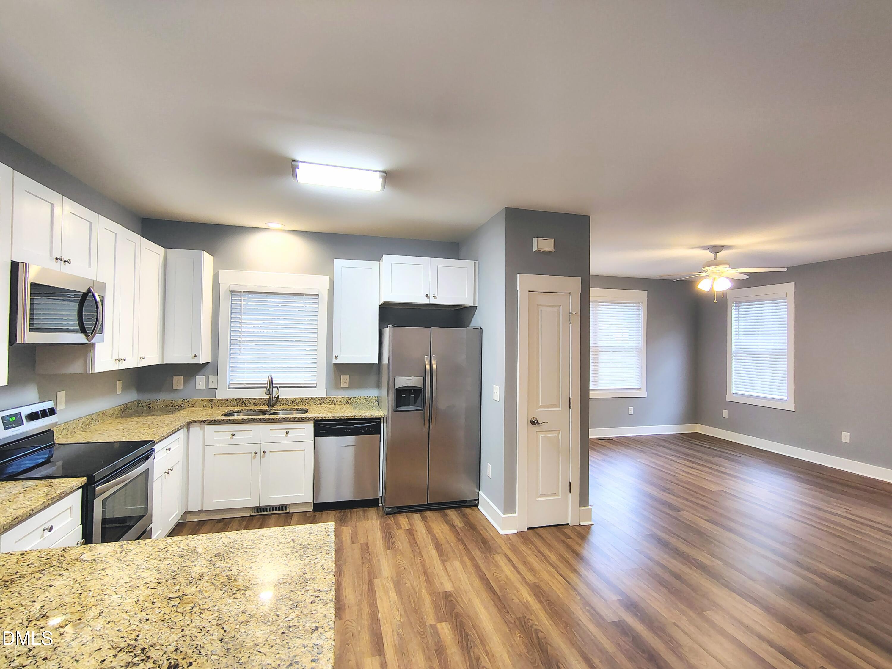 307 Chaplin Street Wendell, NC 27591 - Photo 9 of 24 a kitchen with granite countertop stainless steel appliances and wooden cabinets
