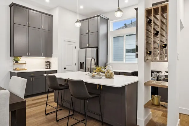 a kitchen with a sink and chairs