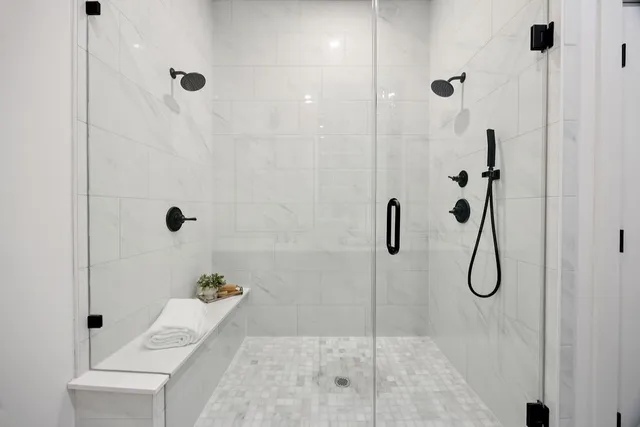 a bathroom with a granite countertop shower
