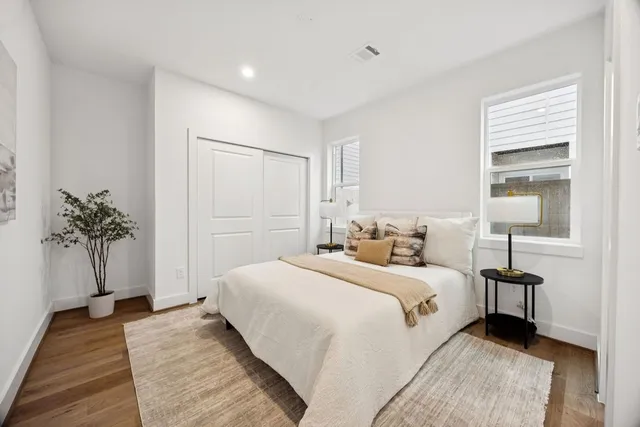 a bedroom with a bed and a potted plant