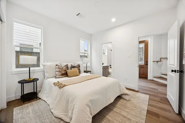 a bedroom with a bed and a table