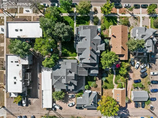 an aerial view of a house with a garden and statue