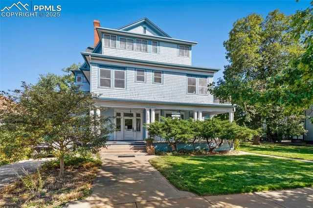 a front view of a house with a garden