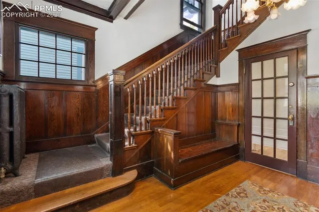 a view of a livingroom with wooden floor and a fireplace