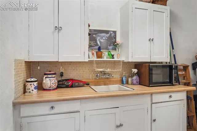 a kitchen with cabinets appliances and a sink