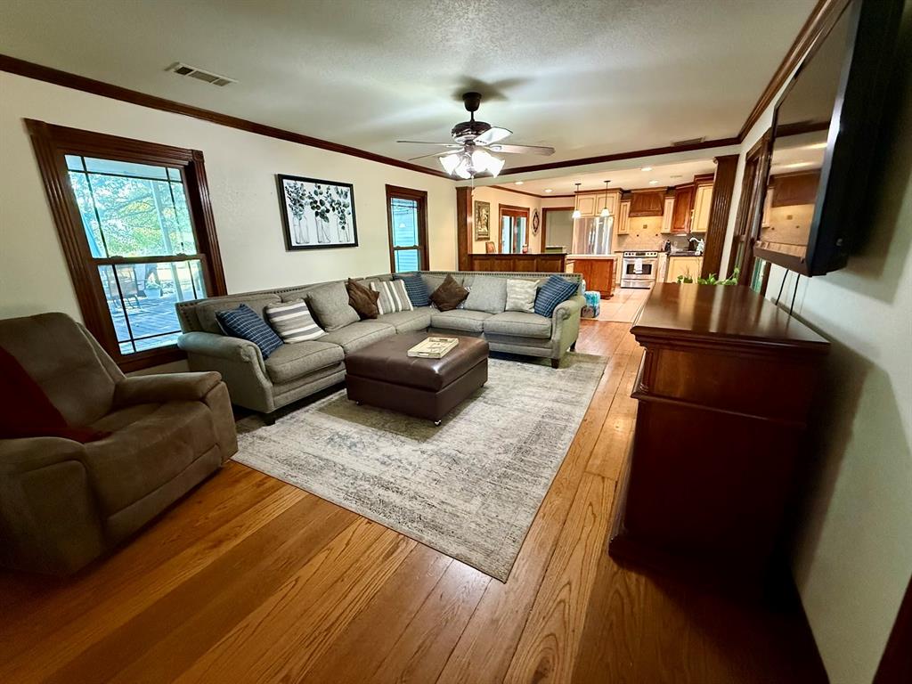 3420 Springfield Road Springtown, TX 76082 - Photo 18 of 38 a living room with furniture and a flat screen tv