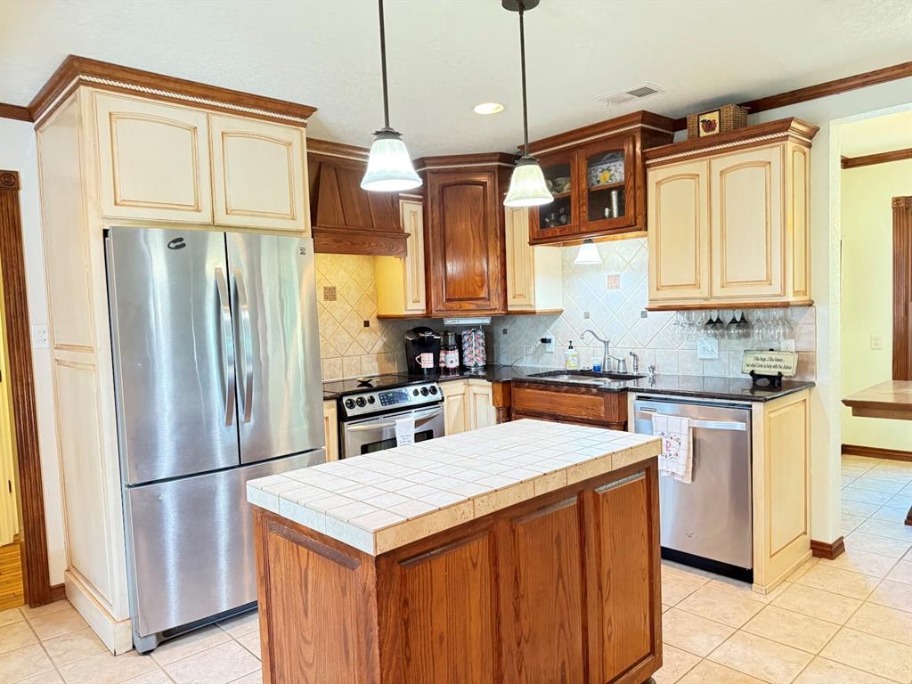 3420 Springfield Road Springtown, TX 76082 - Photo 23 of 38 a kitchen with stainless steel appliances granite countertop a refrigerator a sink and a stove