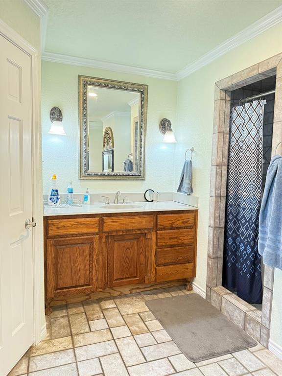 3420 Springfield Road Springtown, TX 76082 - Photo 27 of 38 a bathroom with a granite countertop sink a mirror and a vanity