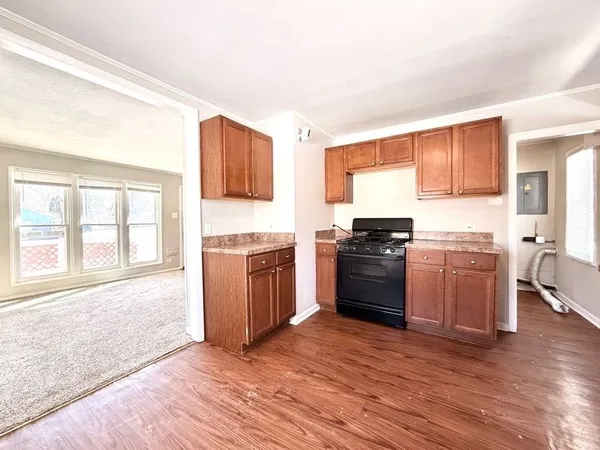 a kitchen with granite countertop a sink cabinets and stainless steel appliances