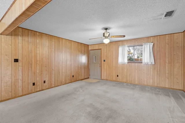 an empty room with windows and closet