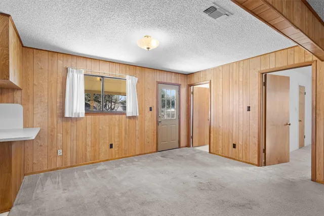 an empty room with windows and closet