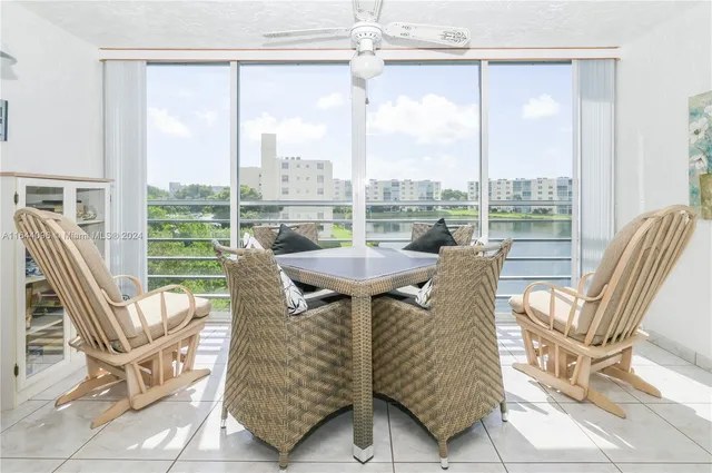 a view of a living room with a table and chairs