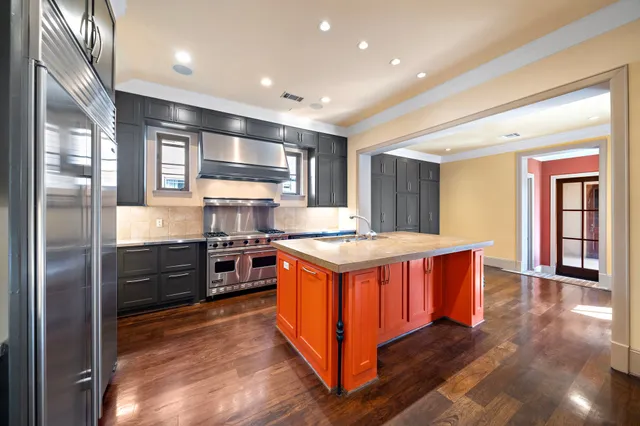 a kitchen with stainless steel appliances granite countertop a stove and a refrigerator