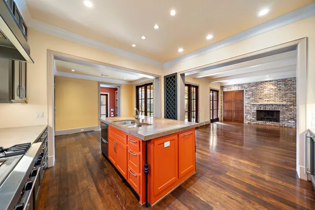 a kitchen with stainless steel appliances granite countertop a stove and a wooden floors