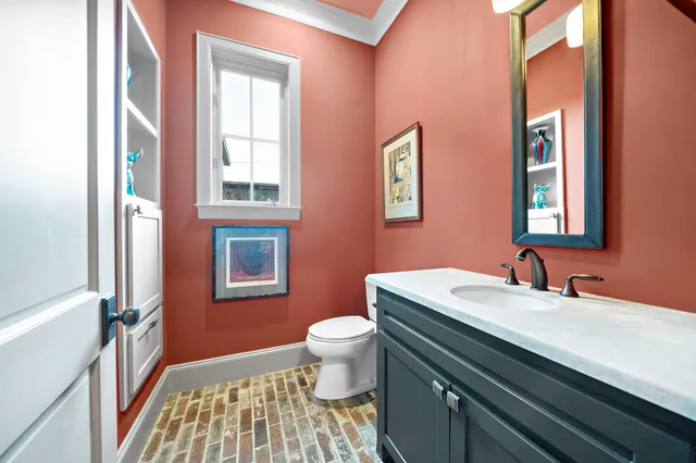 a bathroom with a sink a toilet and a mirror