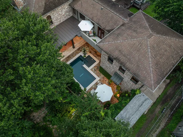 an aerial view of a house with garden space and street view