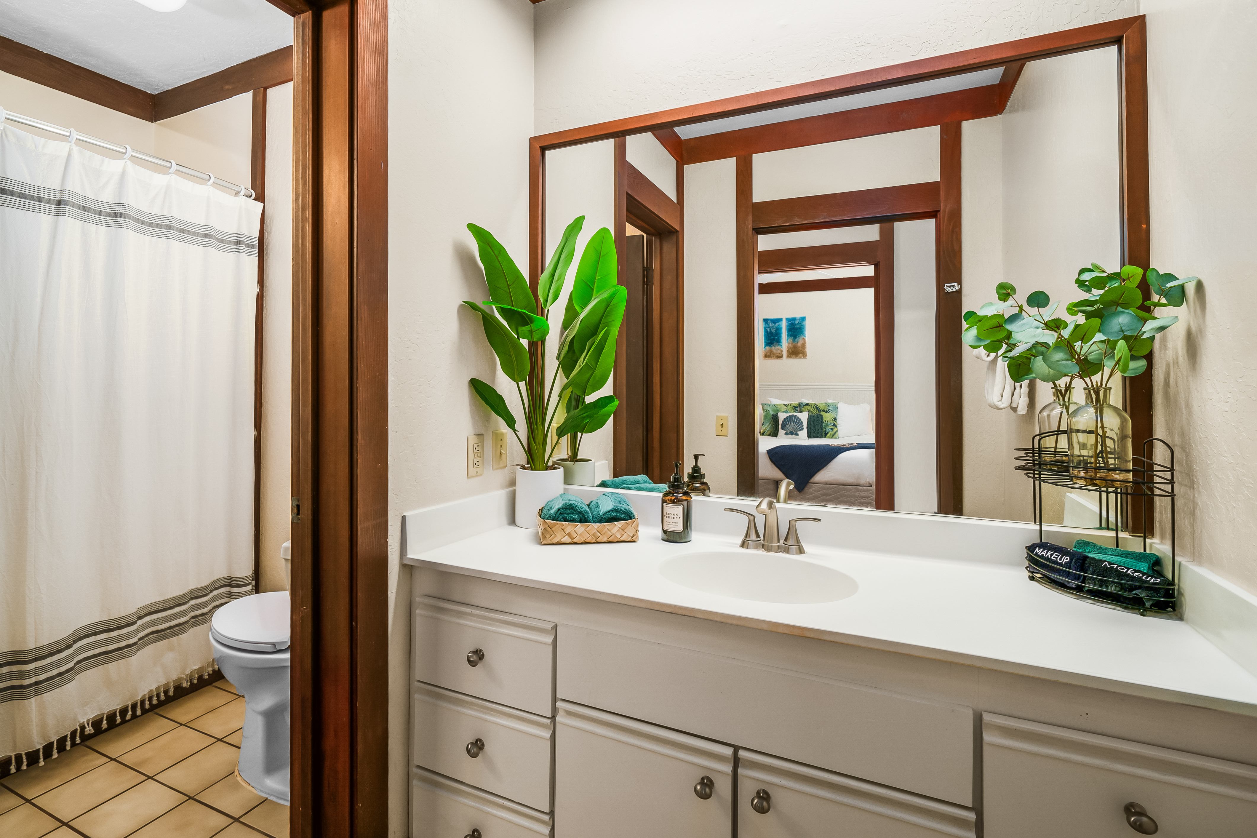 2253 Poipu Road, Unit 169 Koloa, HI 96756 - Photo 4 of 13 a bathroom with a sink a large mirror and a potted plant