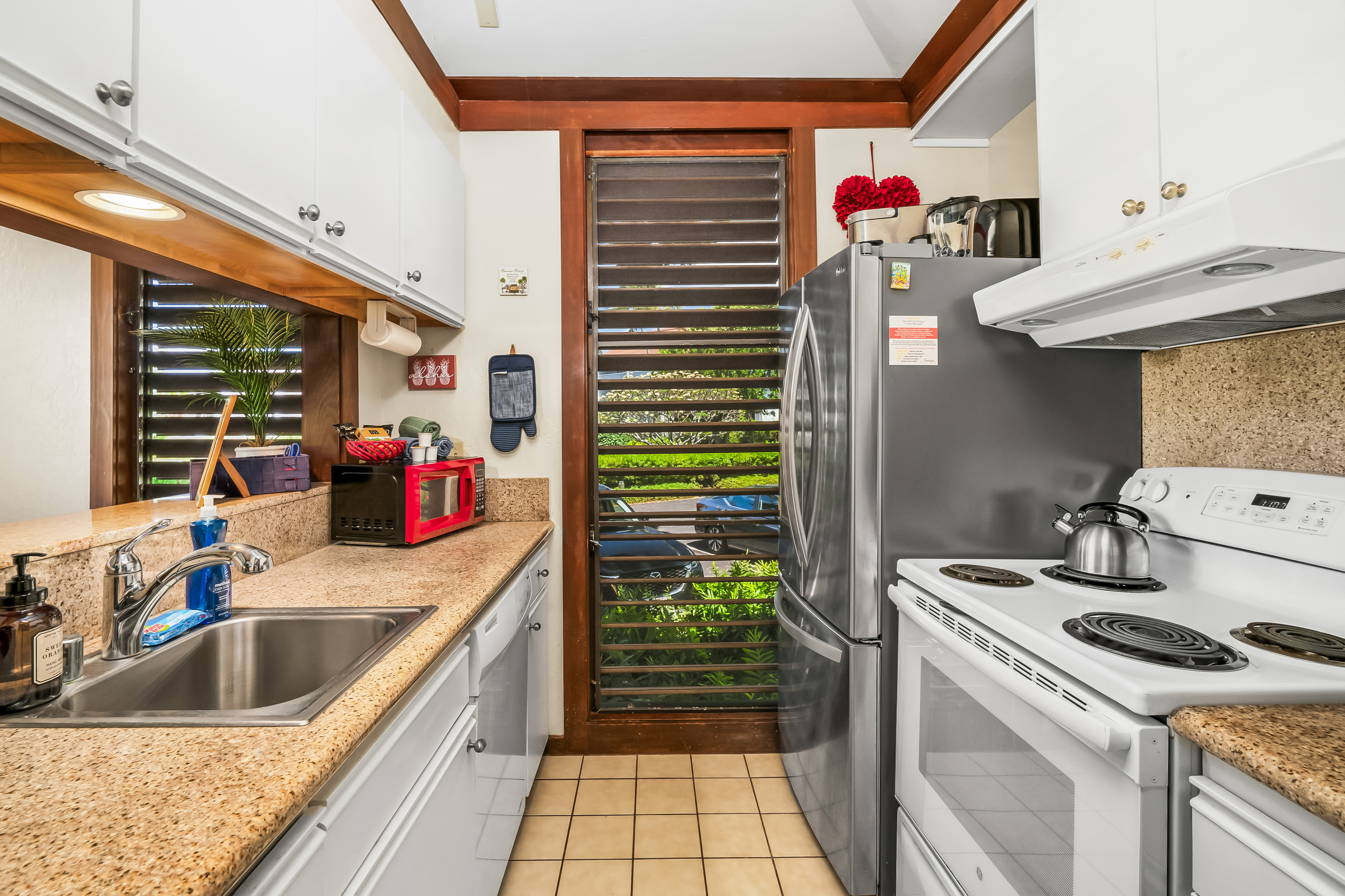 2253 Poipu Road, Unit 169 Koloa, HI 96756 - Photo 6 of 13 a kitchen that has a sink and a stove