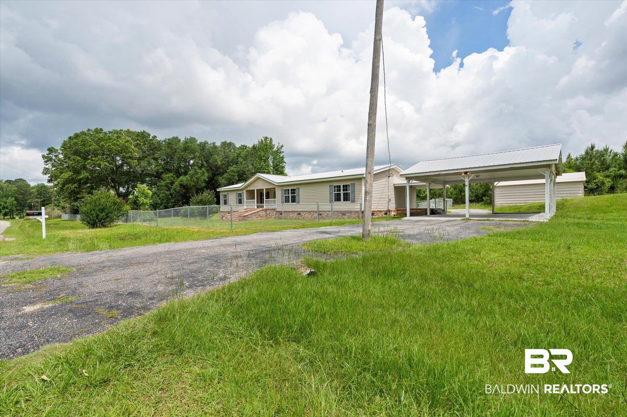 9335 Nathan Jordan Road Millry, AL 36558 - Photo 20 of 20 View of front of house featuring asphalt driveway, a carport, and a metal roof