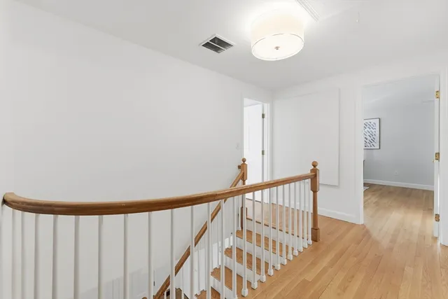 a view of staircase with wooden floor