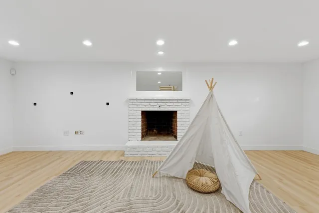 a view of a livingroom with furniture and a fireplace