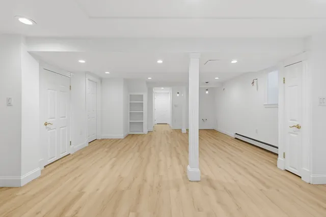 a view of an empty room with wooden floor