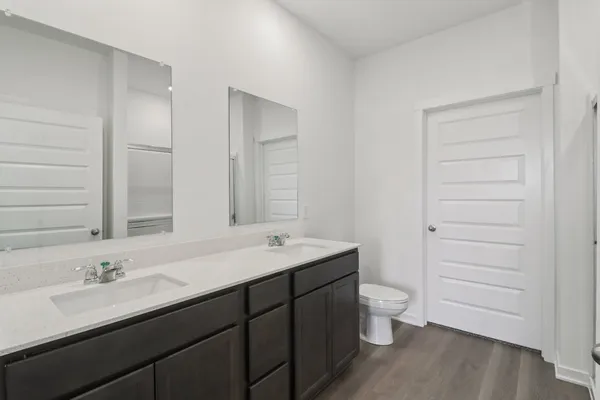 a bathroom with a sink a toilet a shower and a mirror