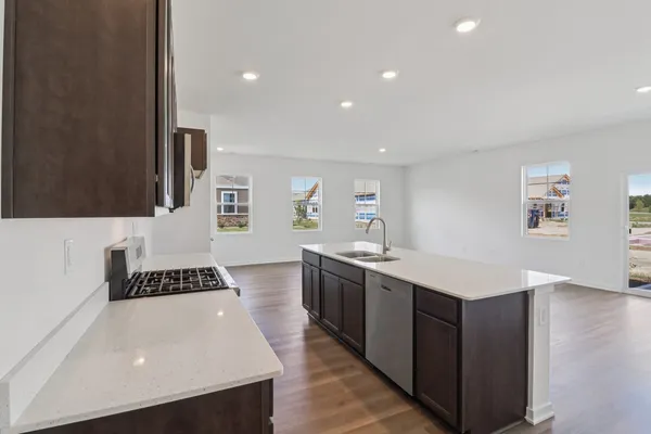 a kitchen with a sink a stove and cabinets
