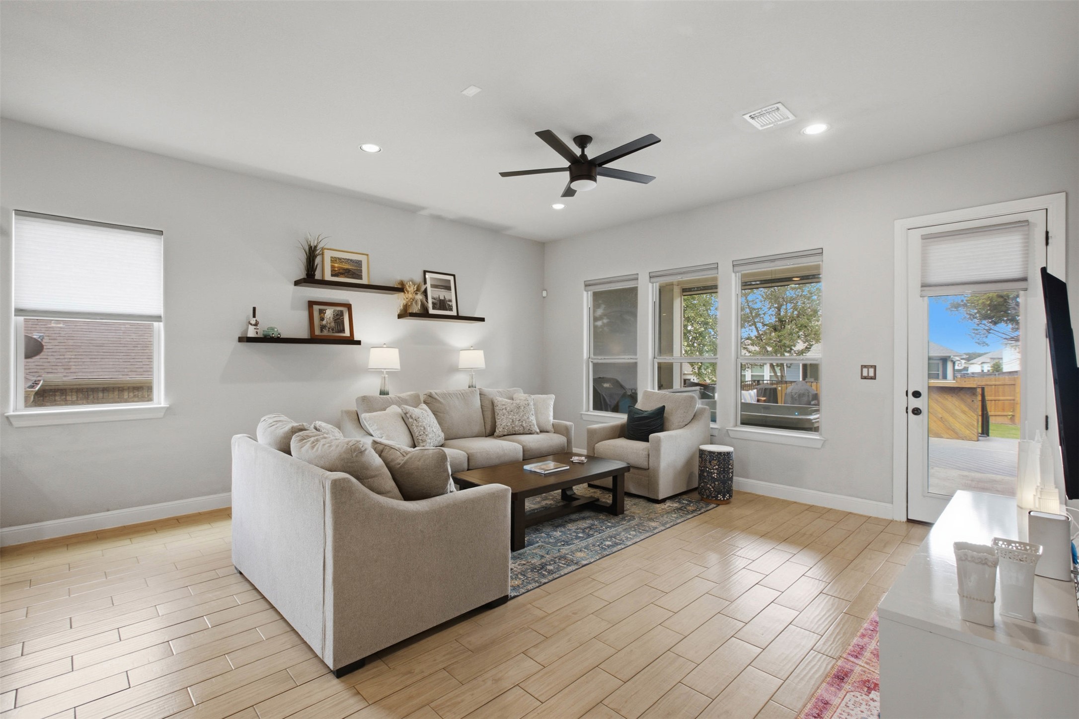 1113 Modoc Way Kyle, TX 78640 - Photo 11 of 34 A comfortable living space boasts recessed lighting, a modern ceiling fan, and elegant wood flooring.