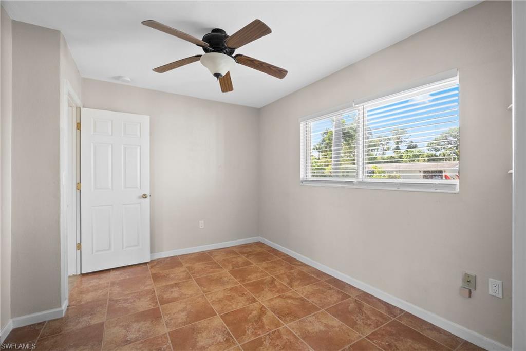 1449 Charles Road Fort Myers, FL 33919 - Photo 11 of 40 Tiled empty room featuring ceiling fan