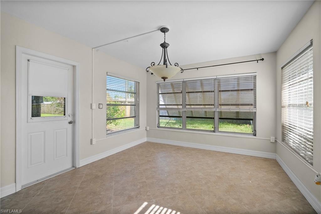 1449 Charles Road Fort Myers, FL 33919 - Photo 15 of 40 Unfurnished dining area featuring tile patterned flooring and a healthy amount of sunlight