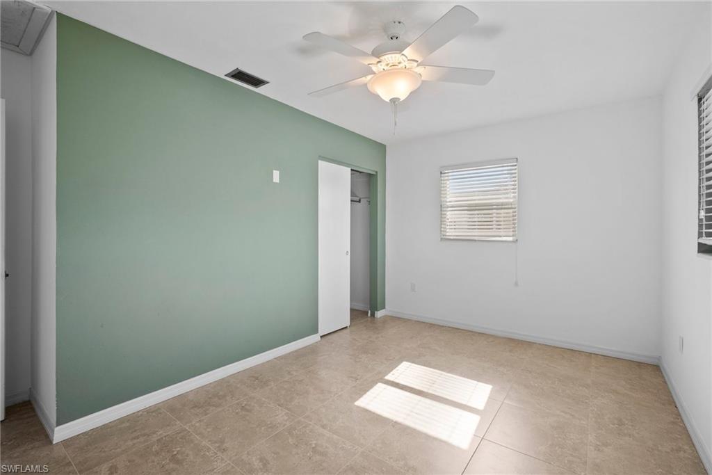 1449 Charles Road Fort Myers, FL 33919 - Photo 21 of 40 Unfurnished bedroom featuring a closet, tile patterned floors, and ceiling fan