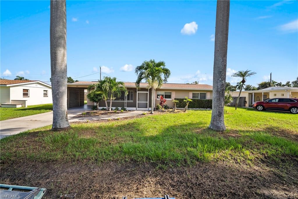 1449 Charles Road Fort Myers, FL 33919 - Photo 5 of 40 Ranch-style home featuring a carport and a front yard