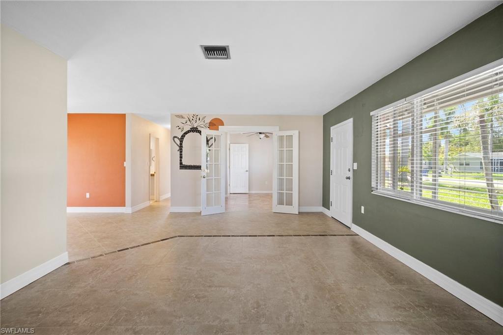 1449 Charles Road Fort Myers, FL 33919 - Photo 8 of 40 Tiled empty room with french doors
