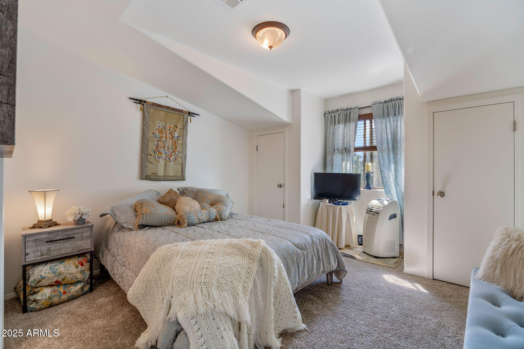6935 Starlight Ridge Road Lakeside, AZ 85929 - Photo 16 of 32 a bedroom with a bed and a painting on the wall