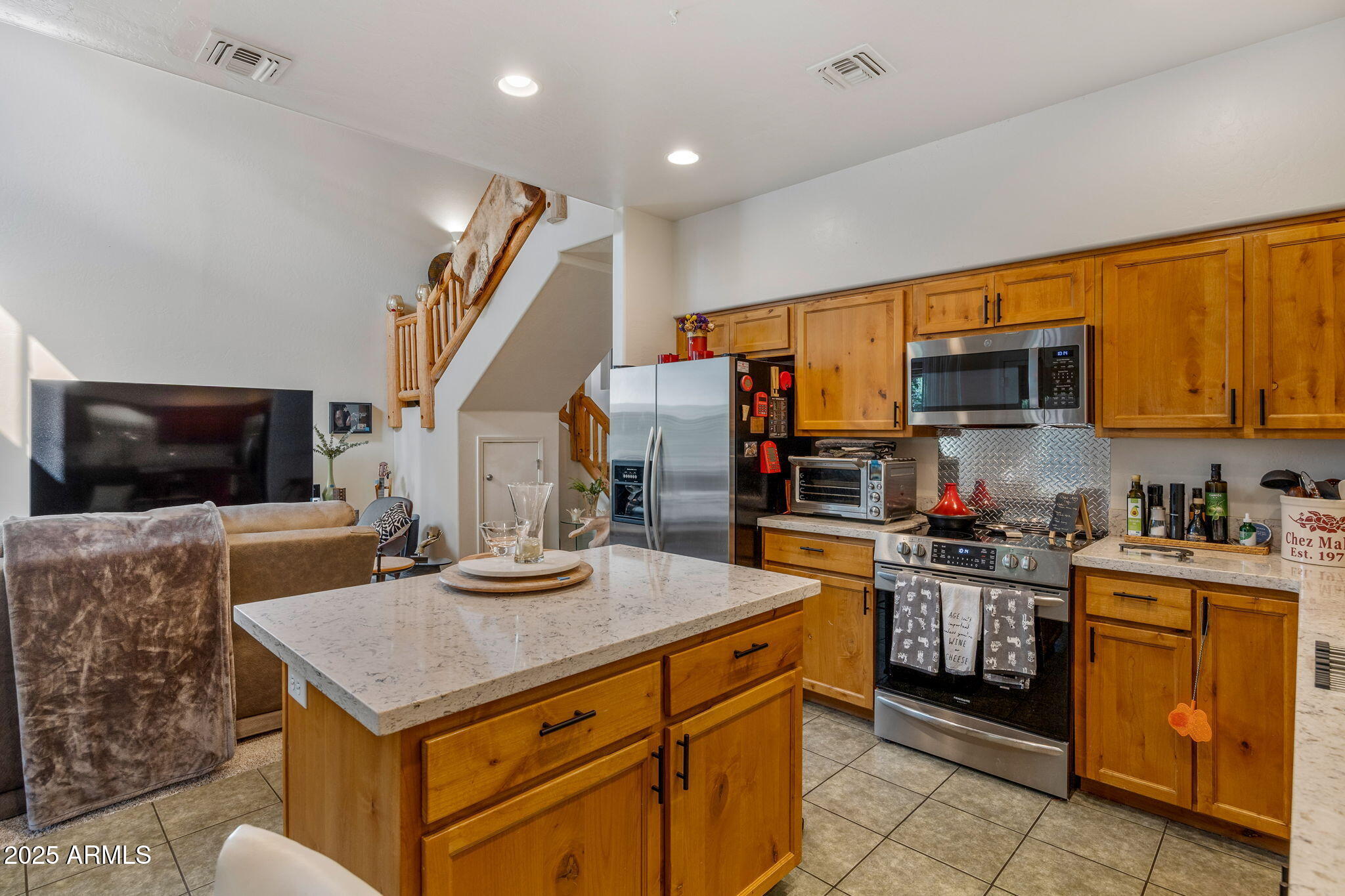 6935 Starlight Ridge Road Lakeside, AZ 85929 - Photo 5 of 32 a kitchen with kitchen island a sink stove and microwave