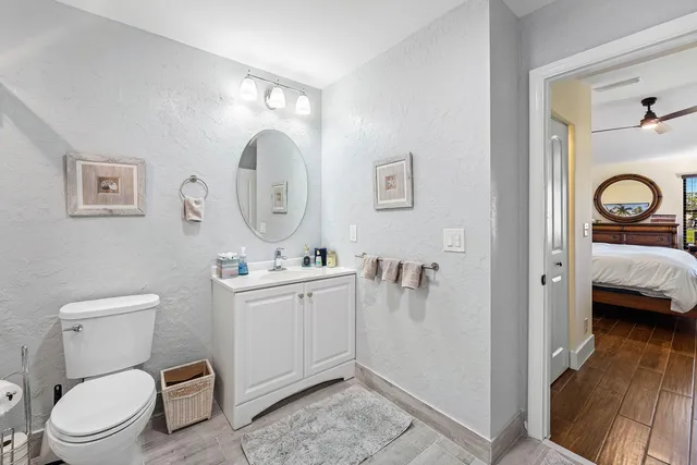 a bathroom with a toilet a sink and shower