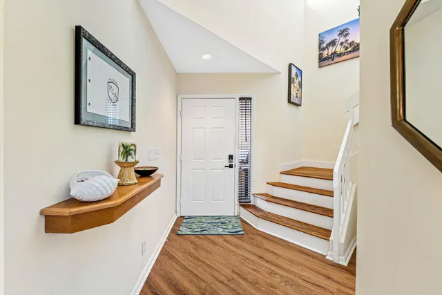 a living room with furniture a rug and white walls