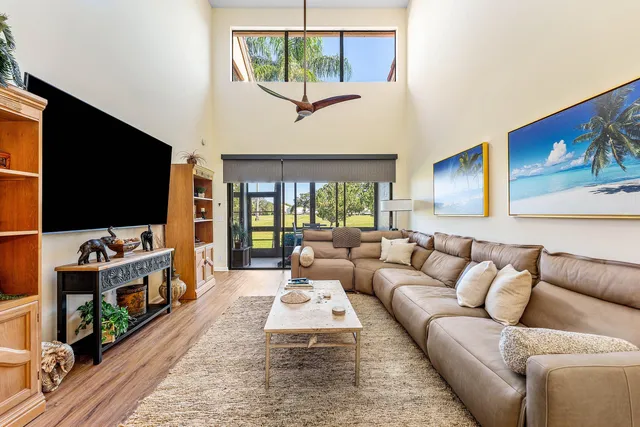 a bedroom with a bed and a lamp on dresser with a large mirror