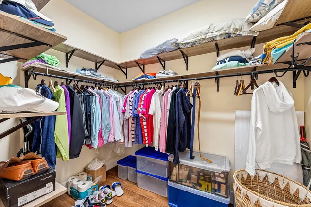 a bathroom with a granite countertop tub sink and mirror