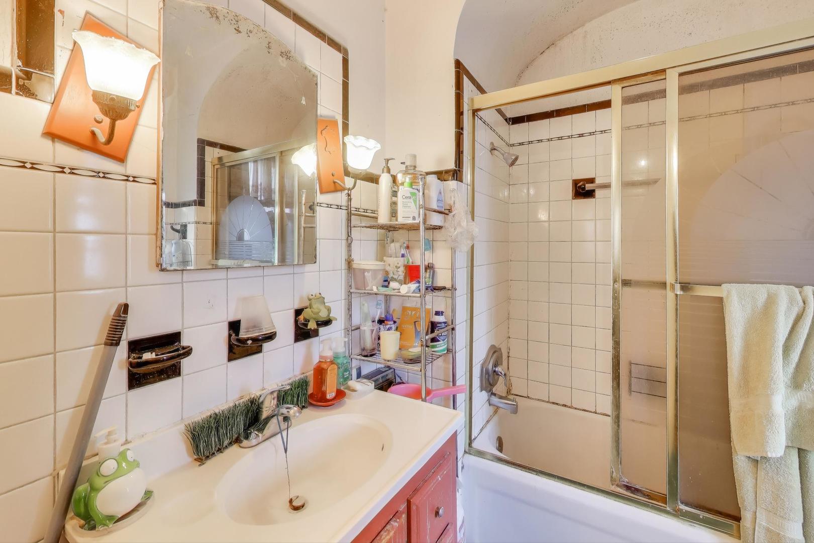 2859 North Mango Avenue Chicago, IL 60634 - Photo 12 of 24 a bathroom with a sink and a shower