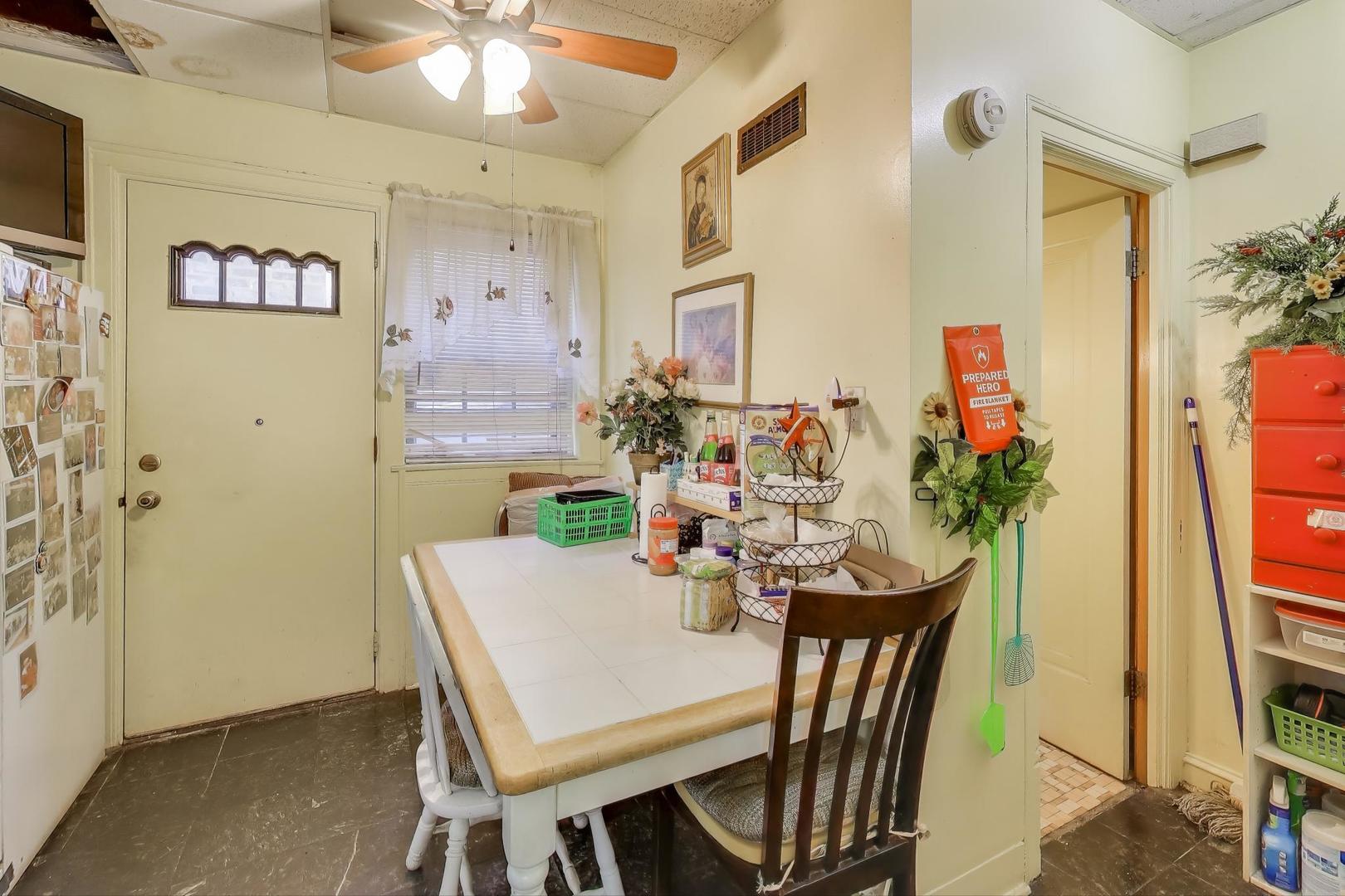 2859 North Mango Avenue Chicago, IL 60634 - Photo 14 of 24 a view of a dining room with furniture and a flat screen tv