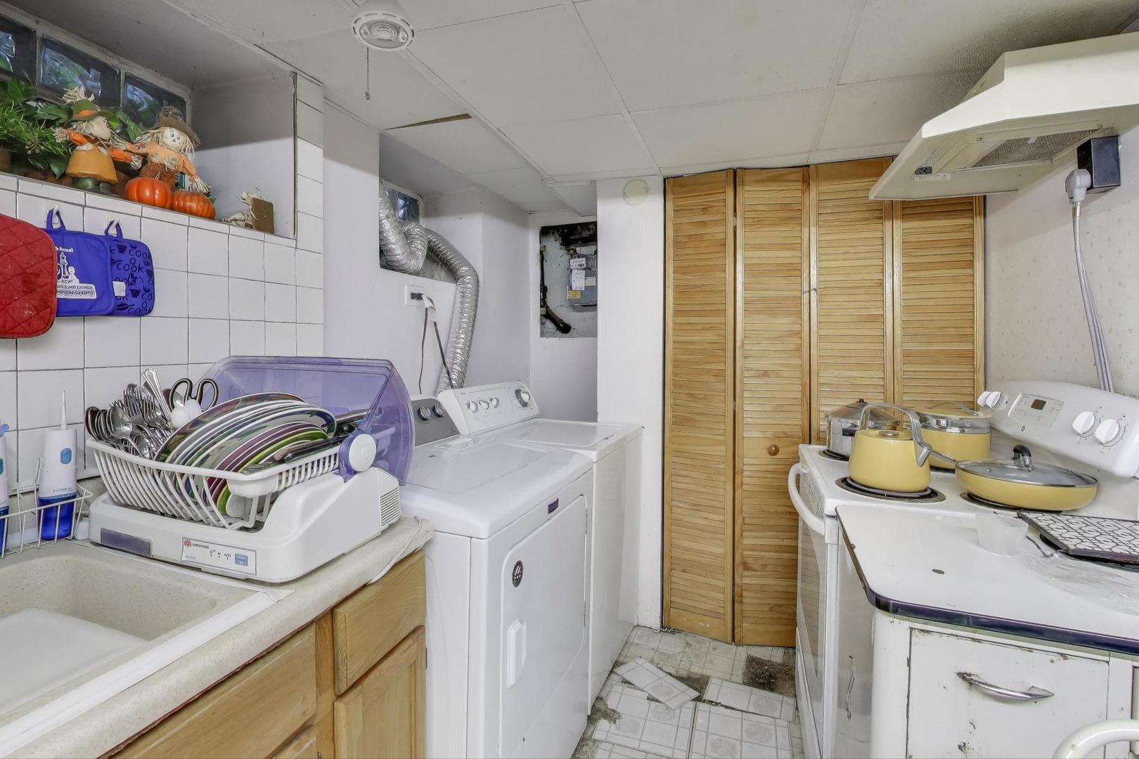 2859 North Mango Avenue Chicago, IL 60634 - Photo 18 of 24 a bathroom with a granite countertop sink a toilet and shower